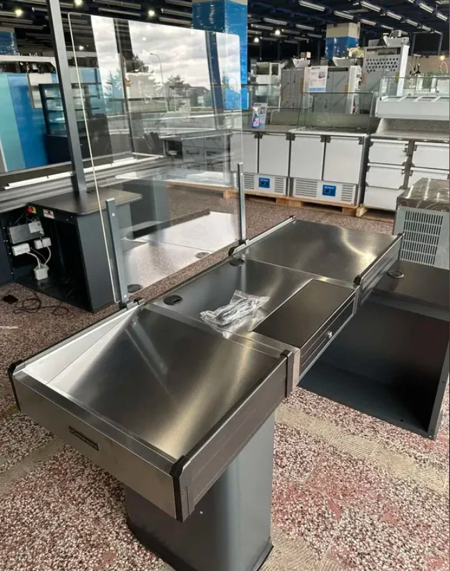 Pokladní box s nepojízdným pásem a úzkým skluzem